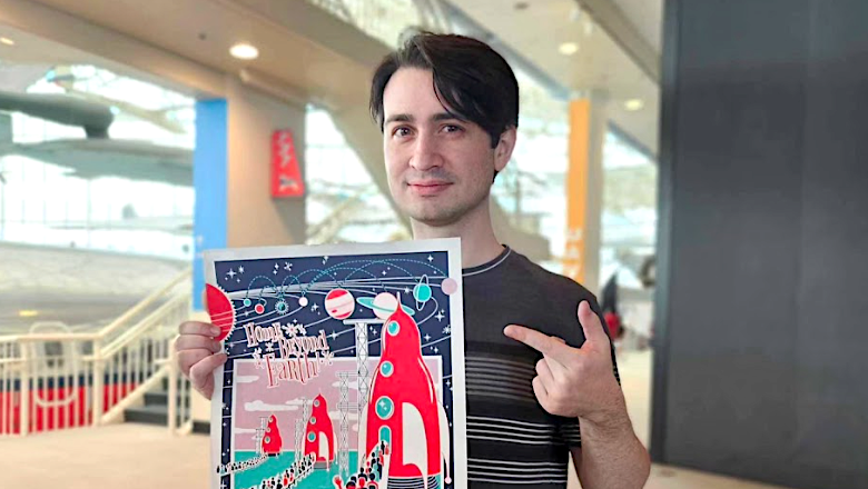 Kevin Laird holding a poster at the Museum of Flight