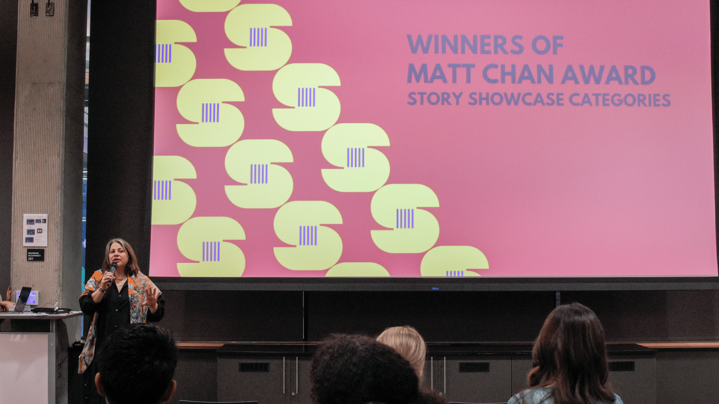 Ekin Yasin, PhD, introduces the Matt Chan Storytelling Award at Communication Leadership's Screen Summit, recognizing outstanding student projects